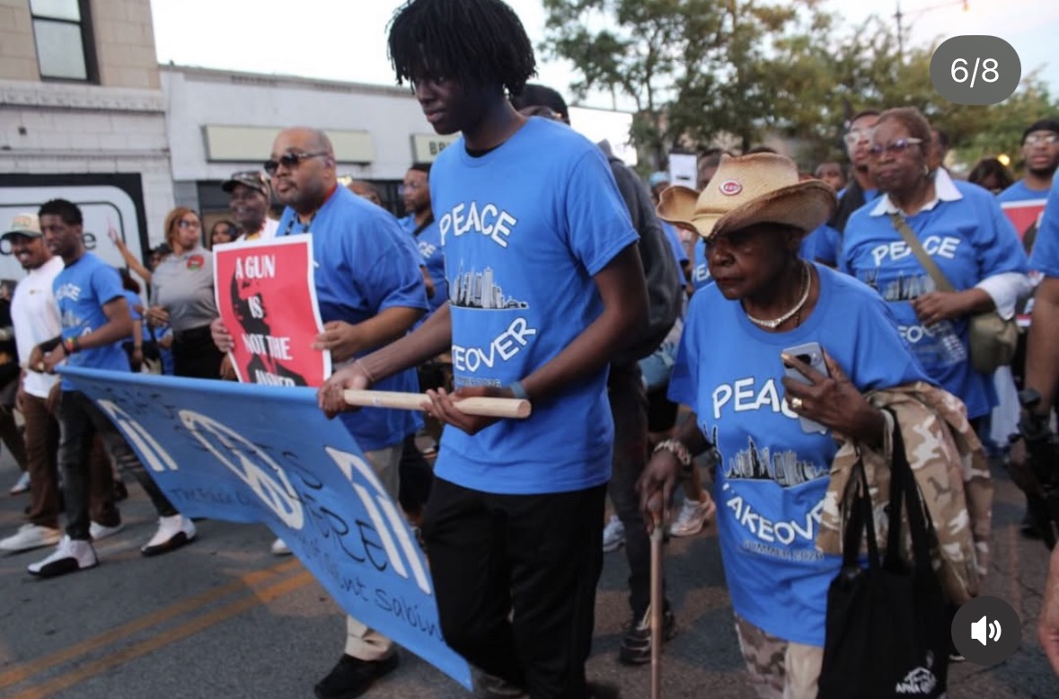 Marchers carrying a Peace Takeover banner