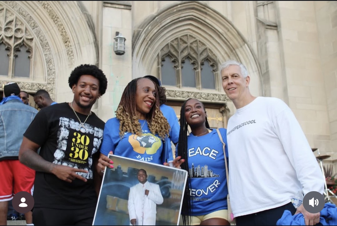 Community members at a peace event on church steps