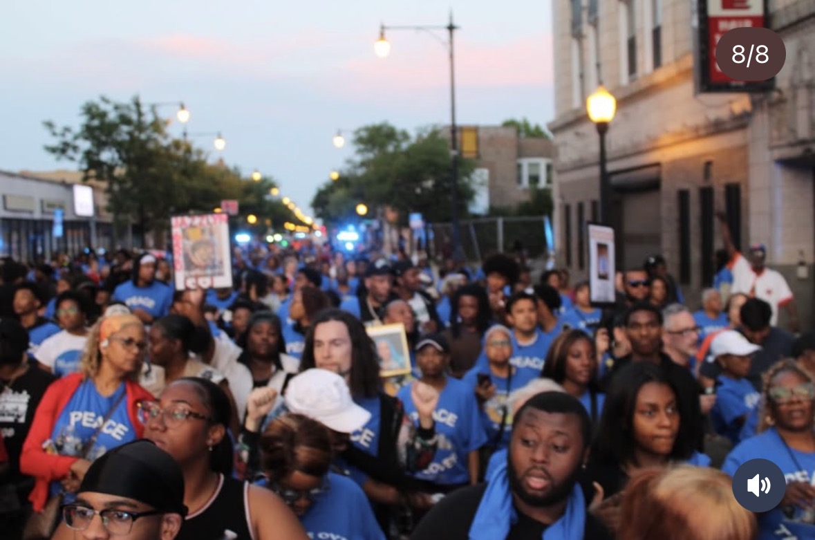 Peace march filling a Chicago street at dusk